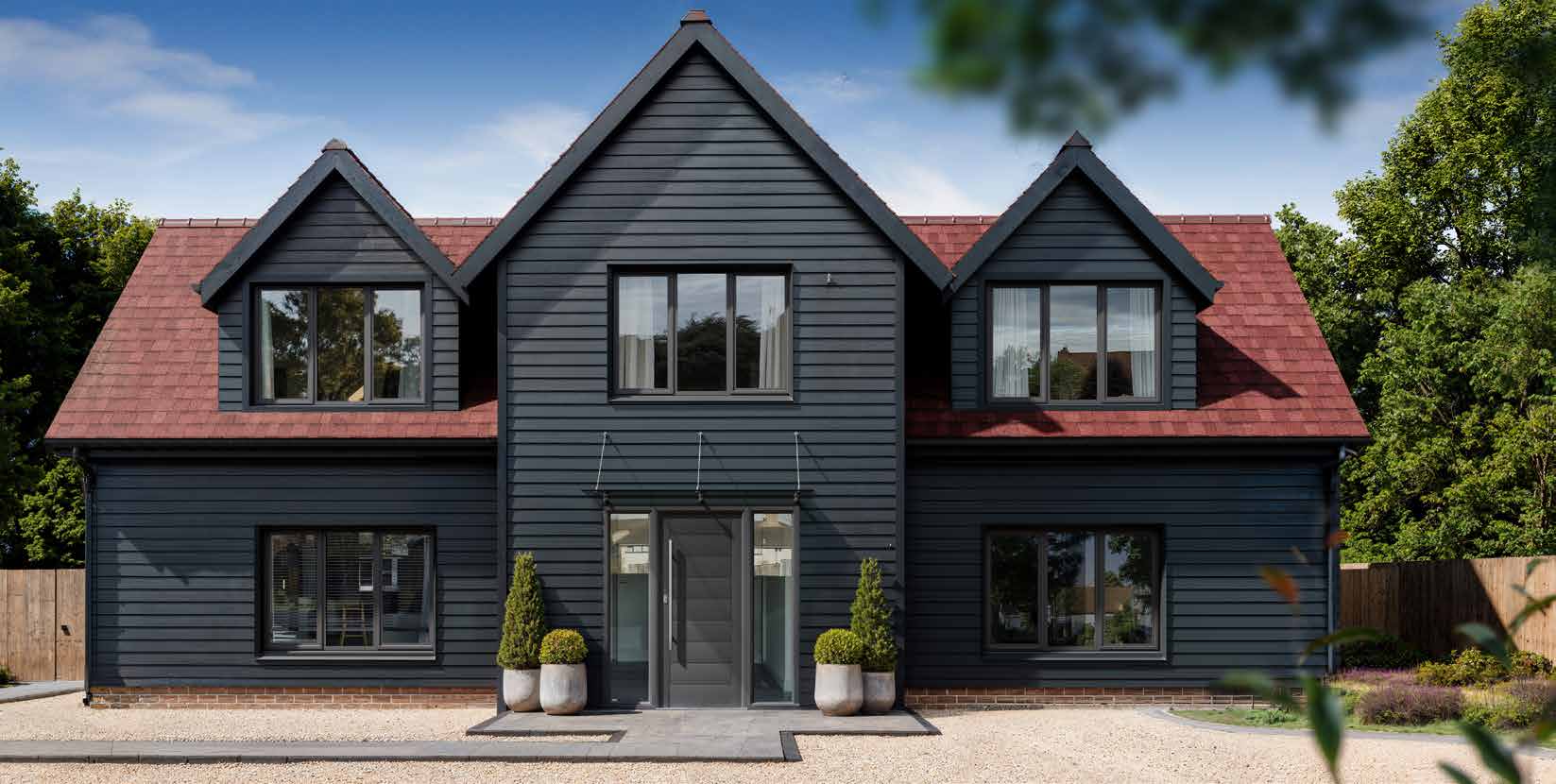 Black timber-clad house with anthracite aluminium casement windows