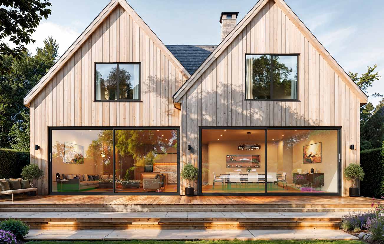 Timber-clad house at dusk with aluminium lift and slide doors