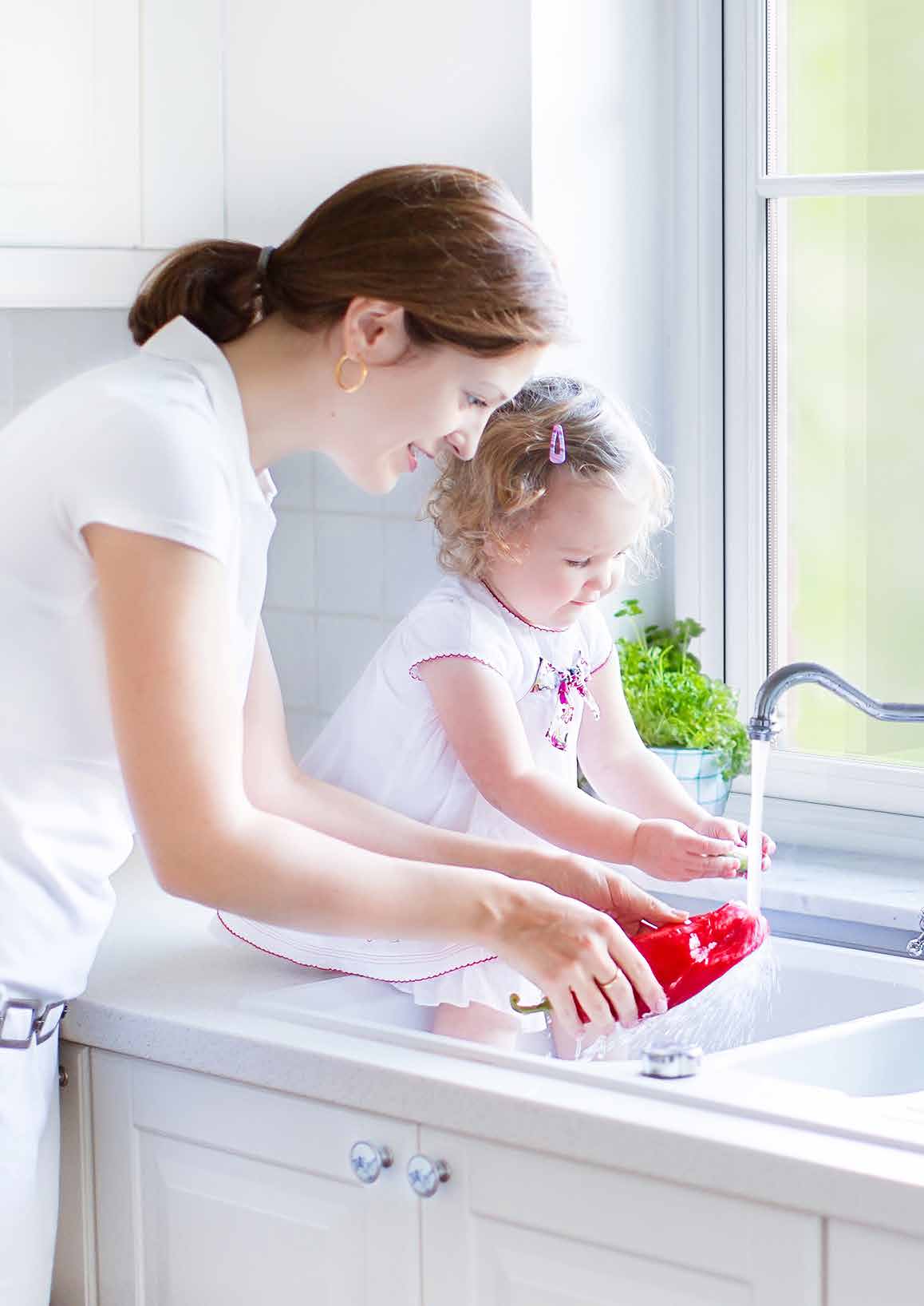 Family at a kitchen sink beside a double glazed window