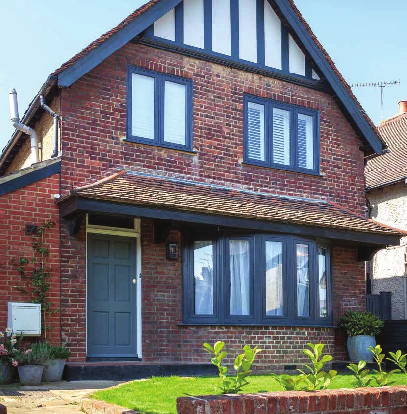 Navy uPVC flush casement windows on a period brick house
