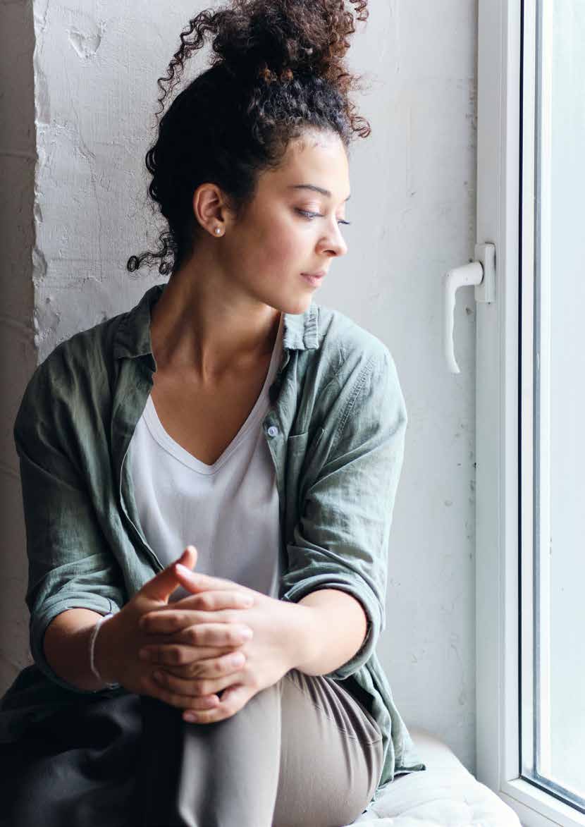 Woman sitting beside an open uPVC tilt and turn window